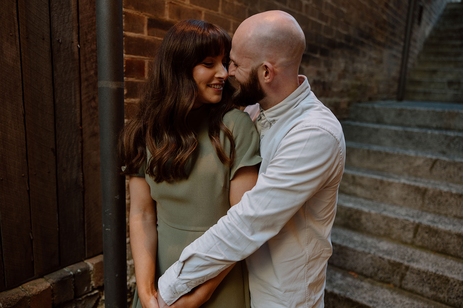 Couple looking at each other at their engagement shoot in Sydney CBD
