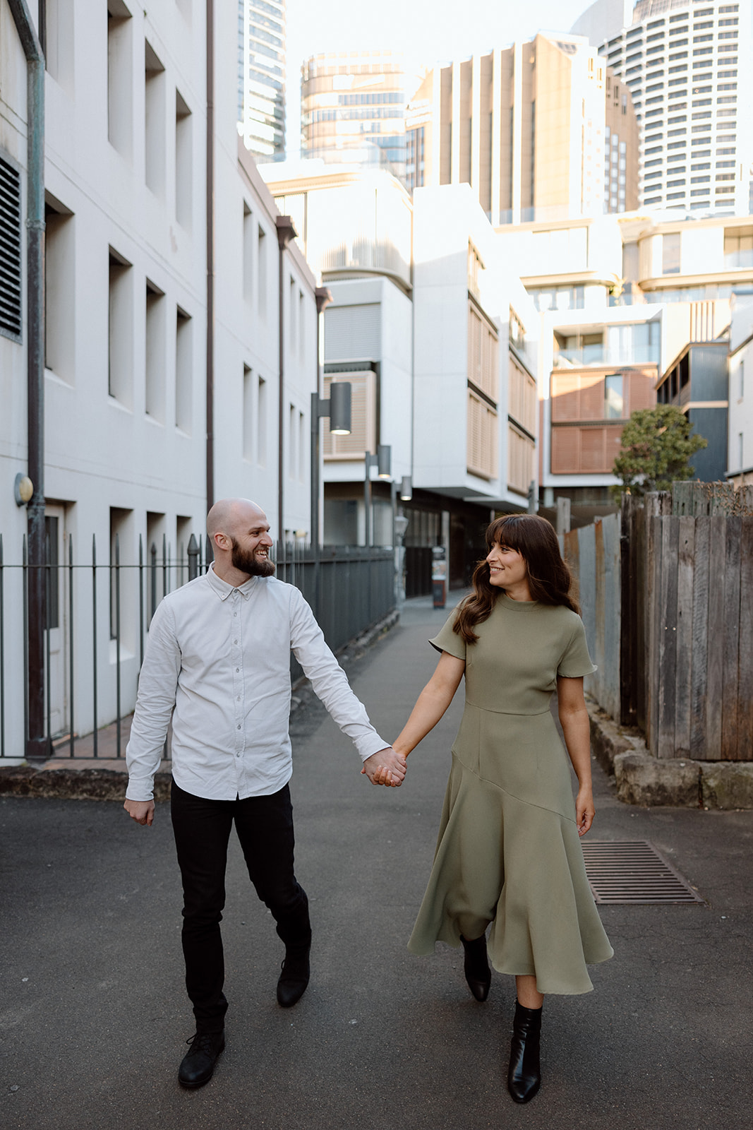 Couple walking in the city at their engagement shoot in Sydney CBD