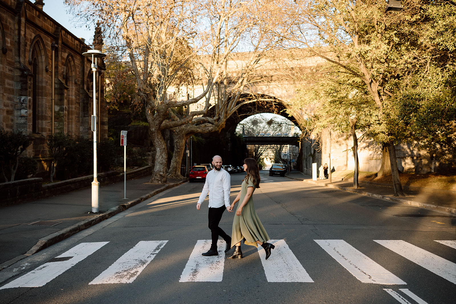 Couple walking in the city at their engagement shoot in Sydney CBD