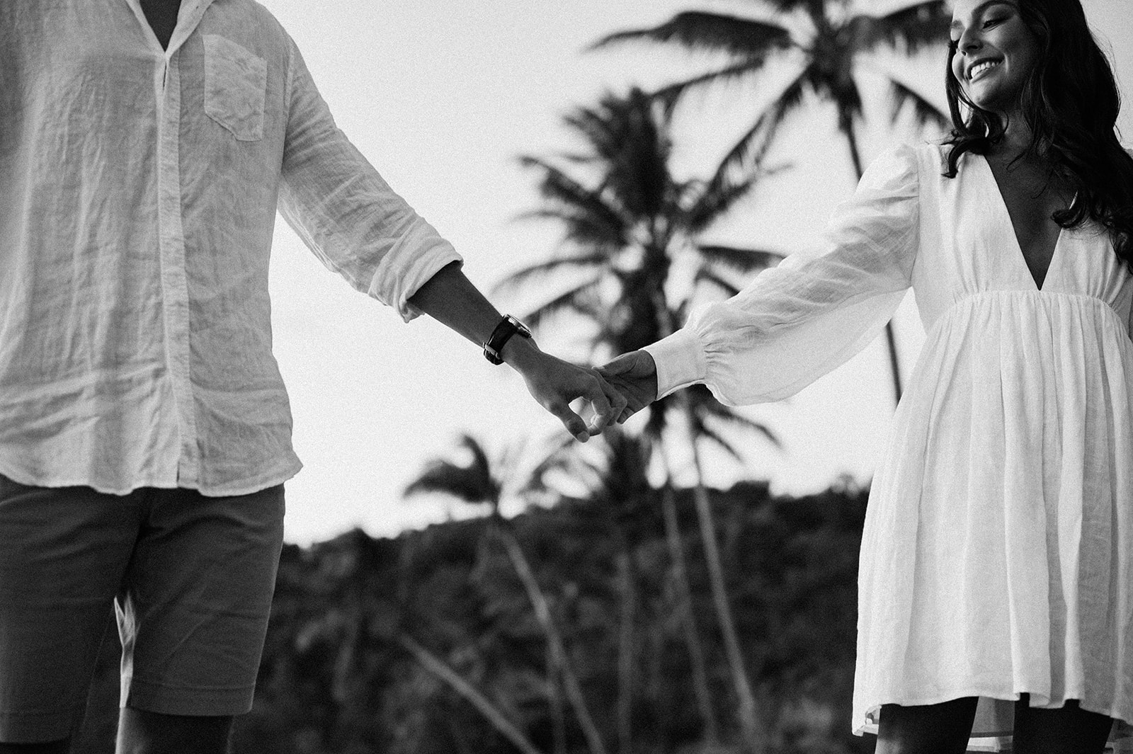 black and white photo with grain on couple having engagement session on the beach