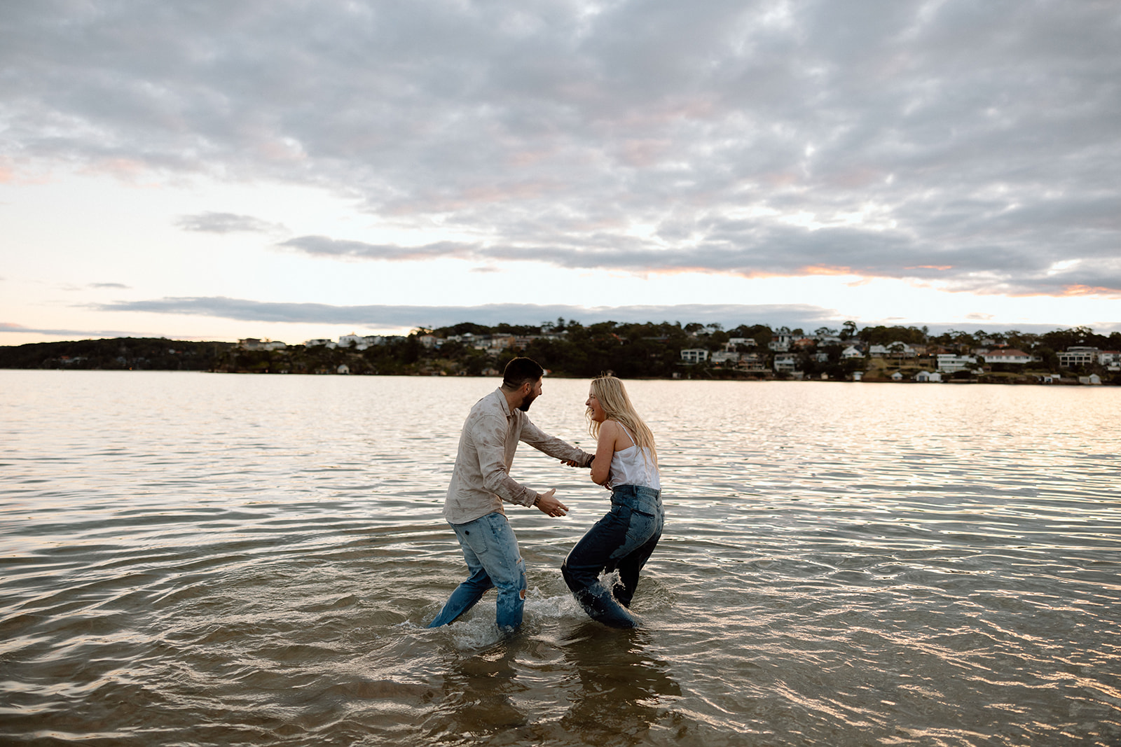 couple playing at the beach during their pre wedding session