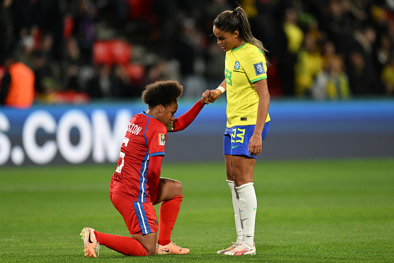 Yomira Pinzon of Panama is helped to her feet by Gabi Nunes of Brazil after the FIFA Women's World Cup match 24 July.