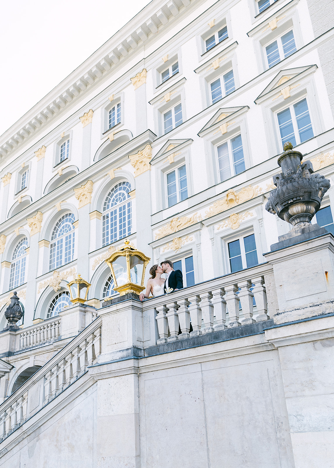Bride and groom kiss for their wedding portraits at Schloss Nypmhenburg