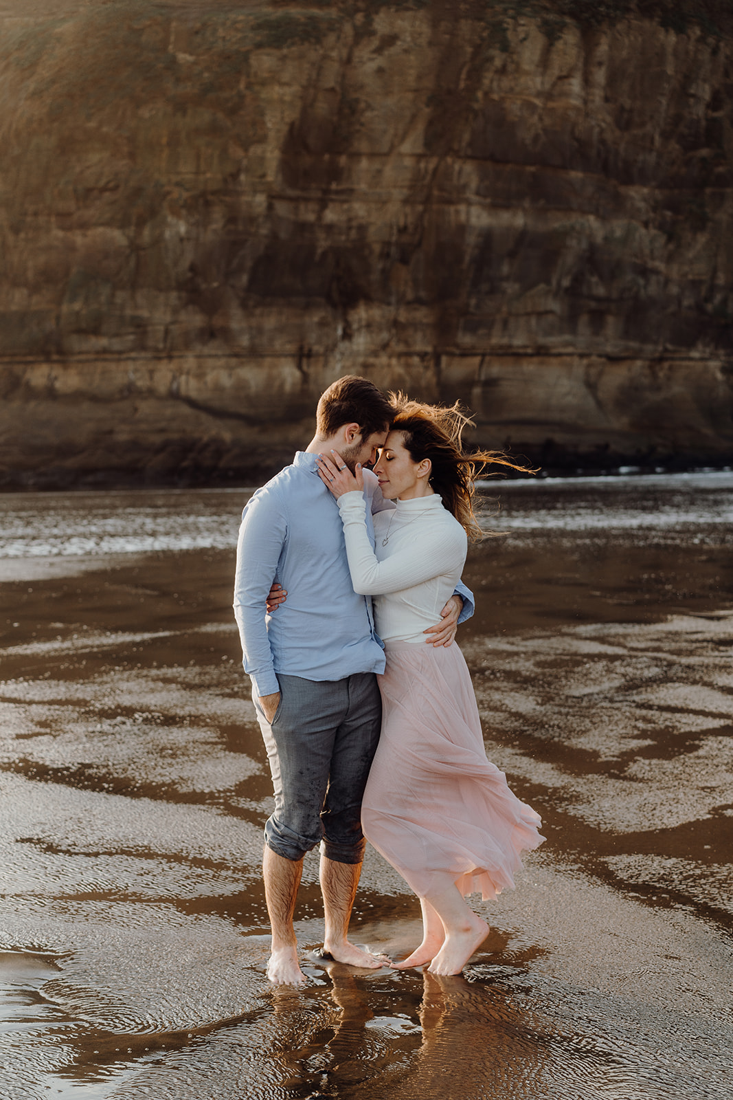 An engaged couple during a pre-wedding photoshoot at Muriwai by Waikato Photographer Haley Adele