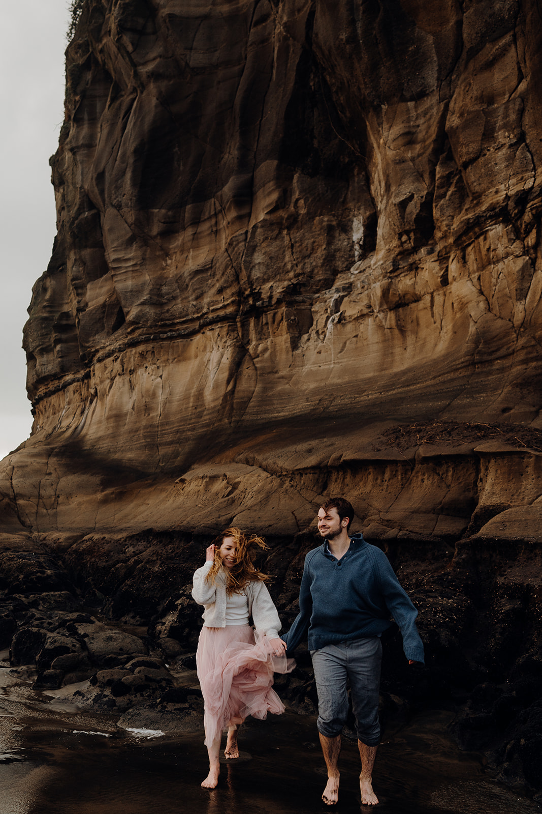 An engaged couple during a pre-wedding photoshoot at Muriwai by Waikato Photographer Haley Adele