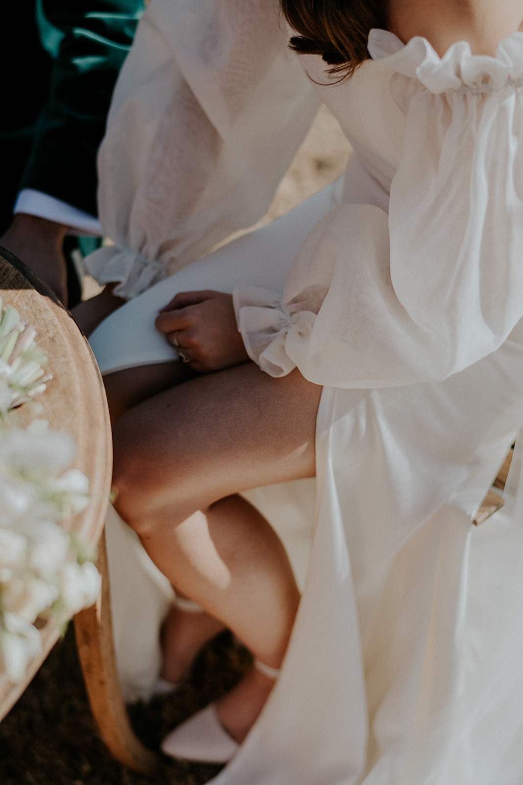 Redleaf wedding brides sleeve dress and shoe while sitting
