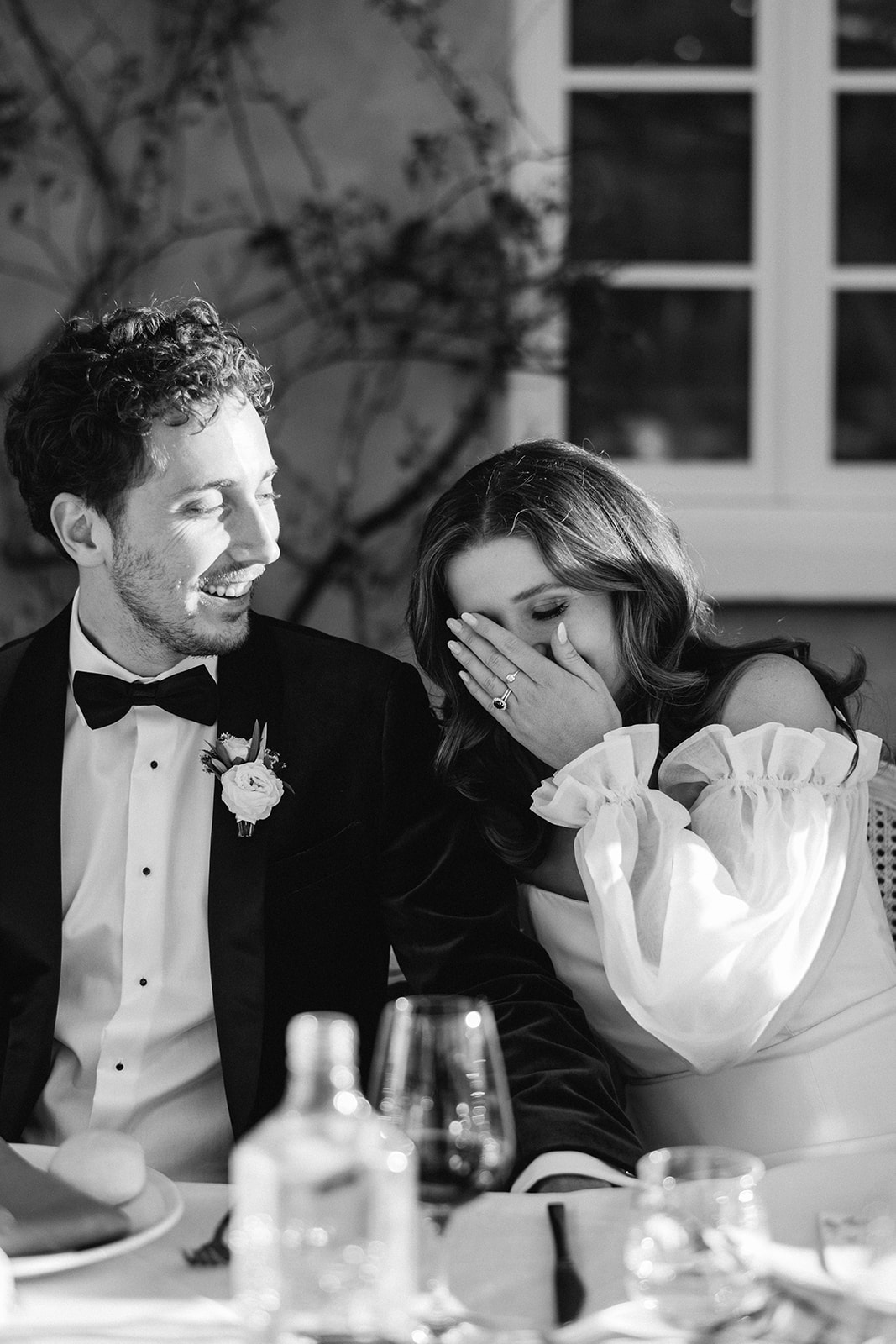 Redleaf wedding couple laughing during speeches black and white