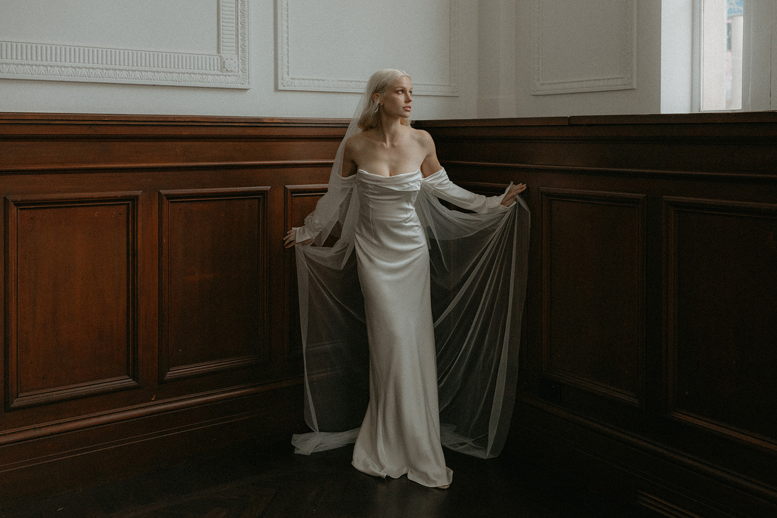 Artistic model looking elegantly in her sheering gown in a historic venue