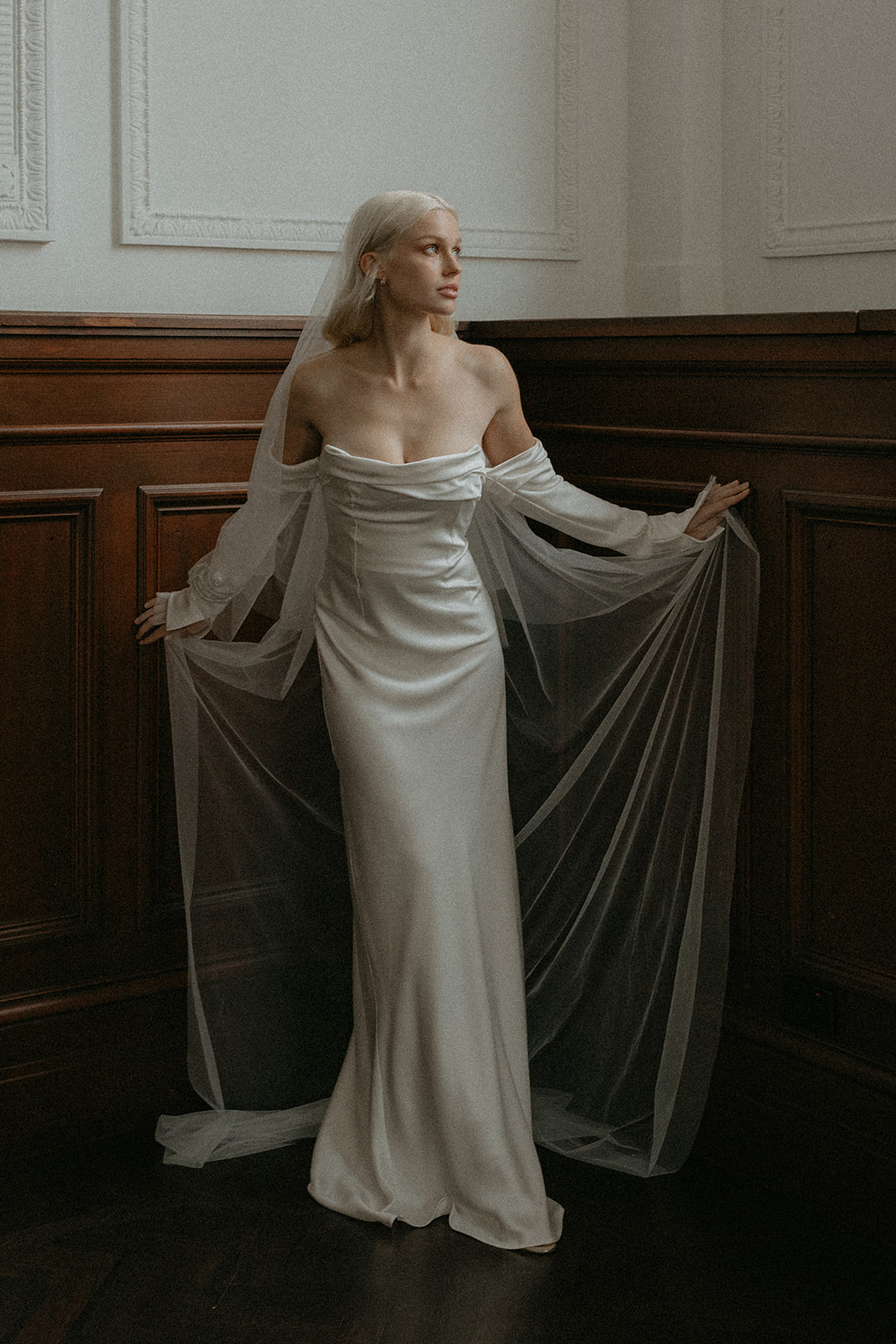 Artistic model looking elegantly in her sheering gown in a historic venue