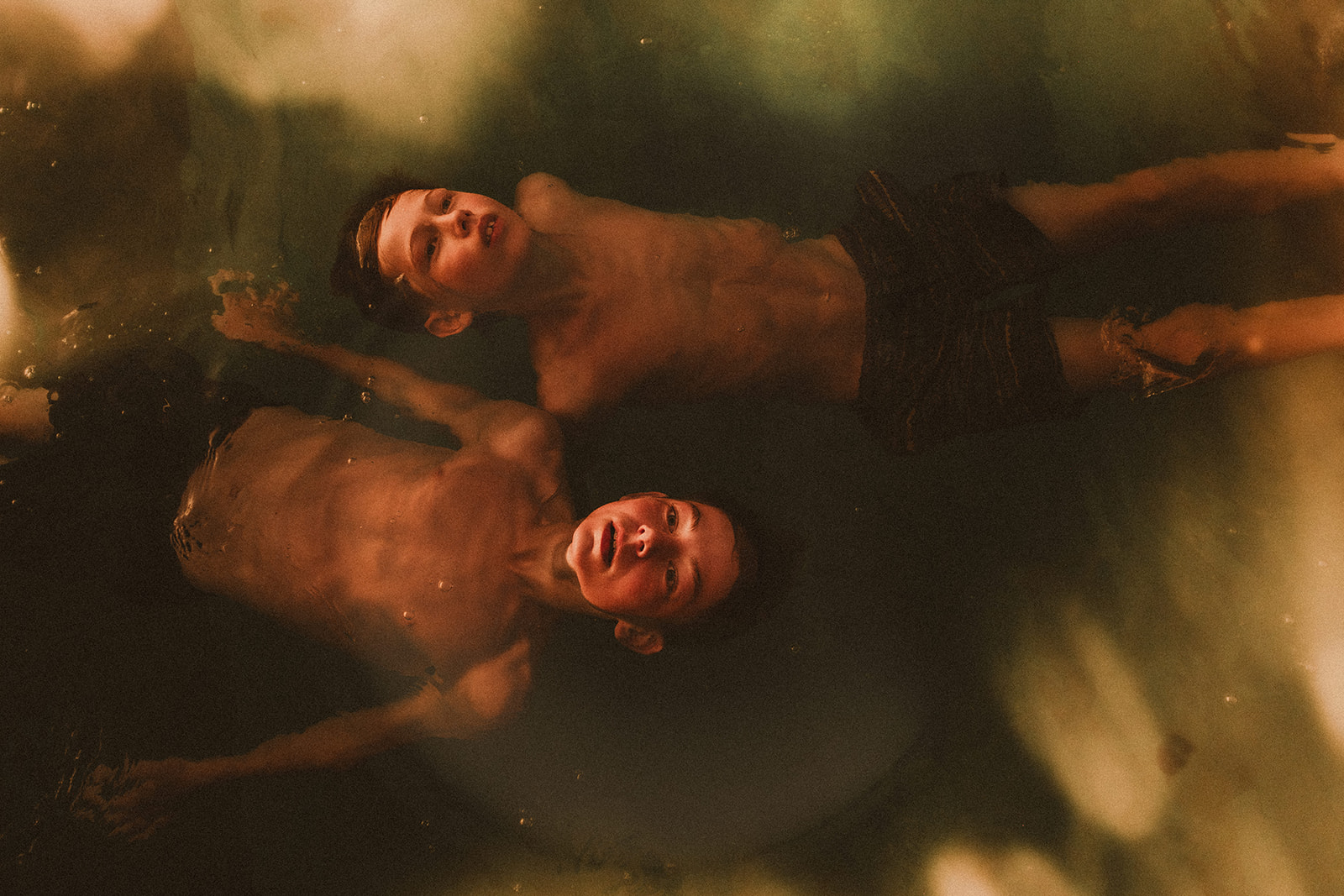 Two boys floating in water