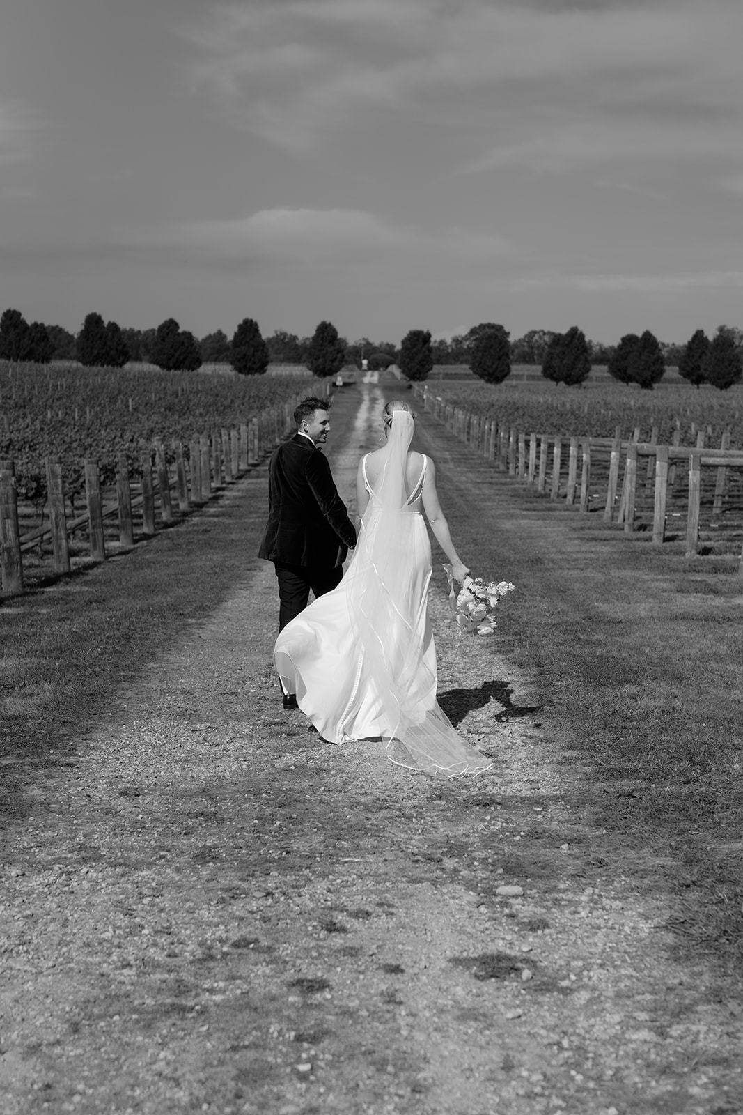 zoe and nathan walking through the winery at mitchelton wine wedding venue