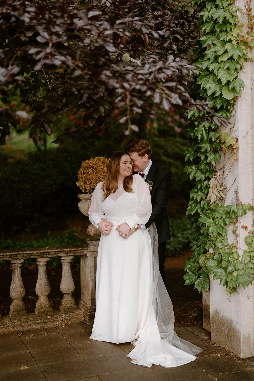 A bride and groom cuddling at their luxury Milton Park Country House wedding.