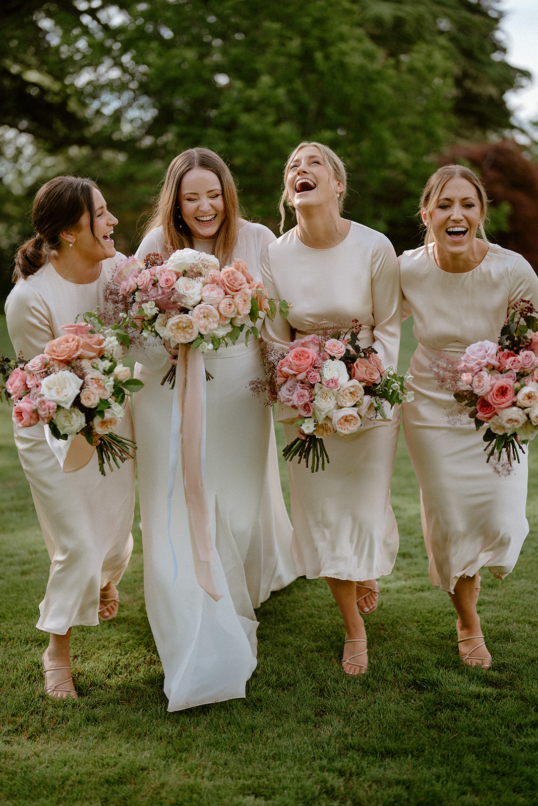 A group of bridesmaids having a candid laugh captured by Dan Cartwright Photography at a Milton Park wedding.
