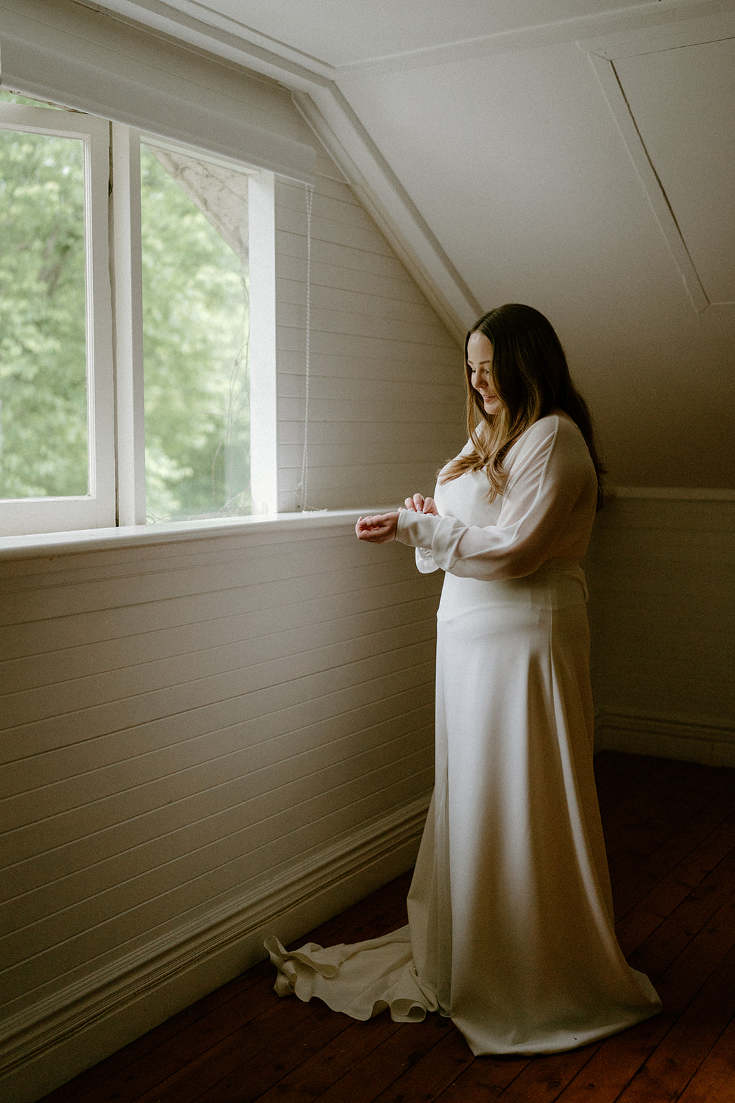 A bride in a luxe wedding dress getting ready at her Milton Park Country House wedding.