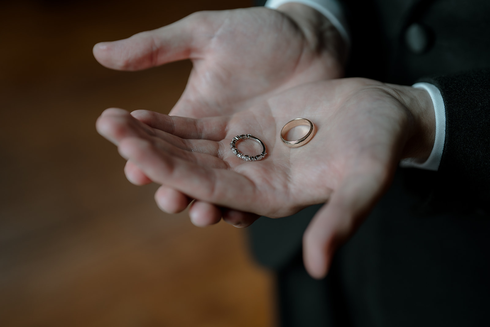 Close-up of groom holding wedding bands. Melbourne storytelling photographer documents the moment.