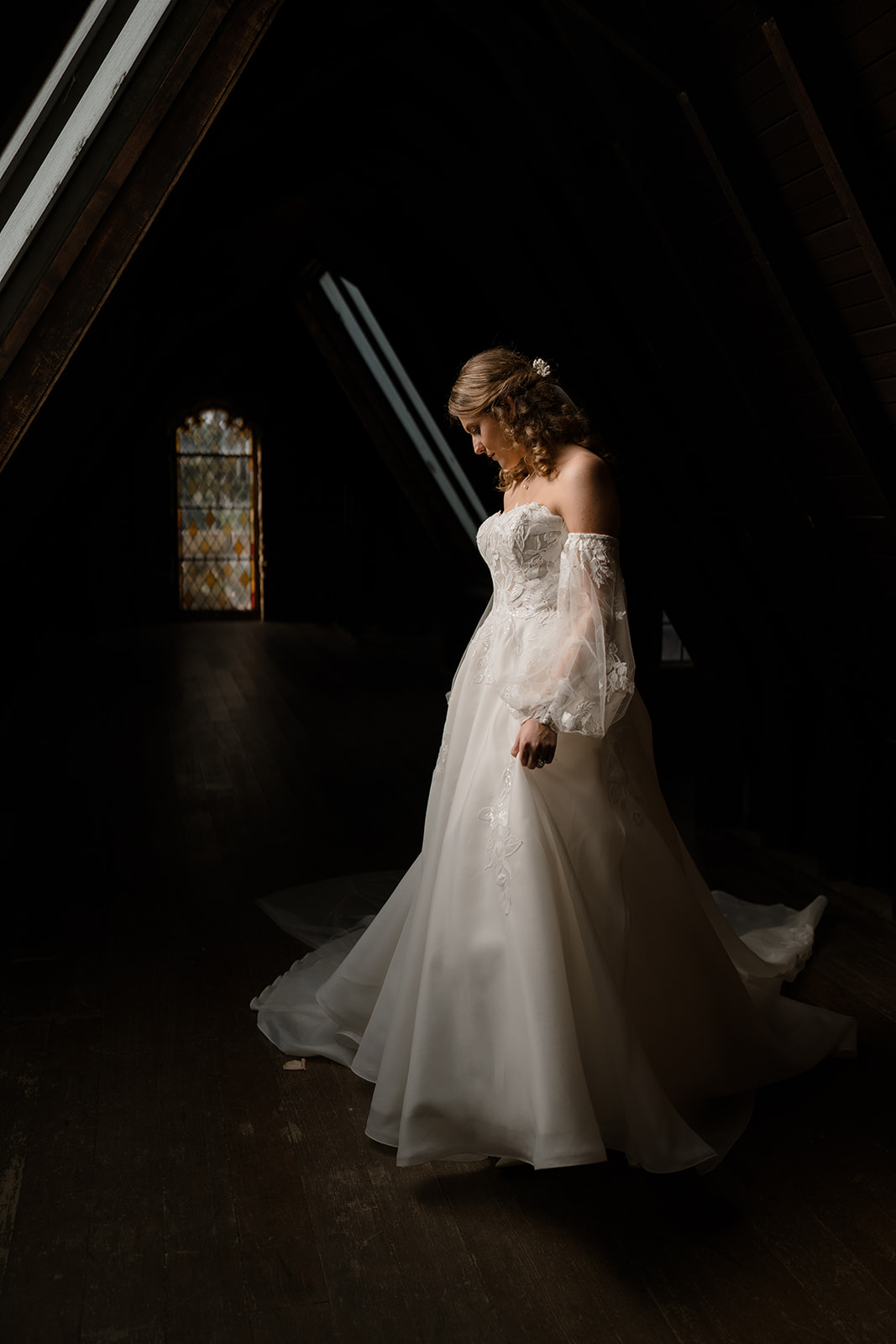Frosted window light creates a dreamy atmosphere for bride's portrait at Montsalvat.