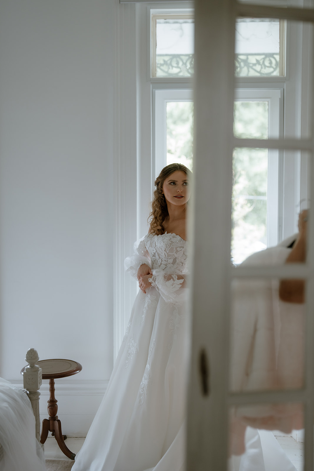 Radiant bride in a timeless wedding dress, exudes anticipation as she prepares for her wedding at Montsalvat