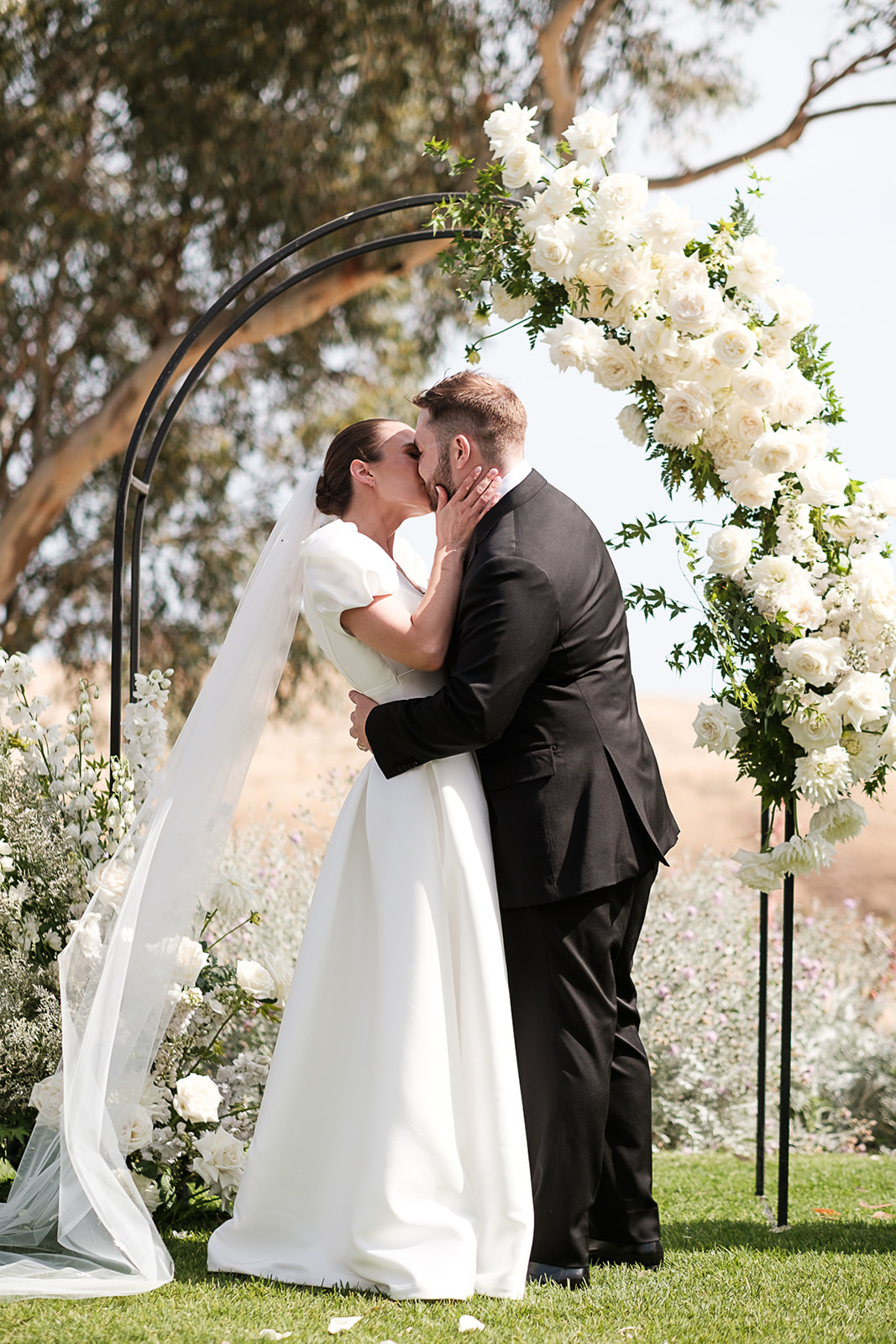 Bride and Groom seal their vows with a kiss on their wedding day at Kingsford Estate
