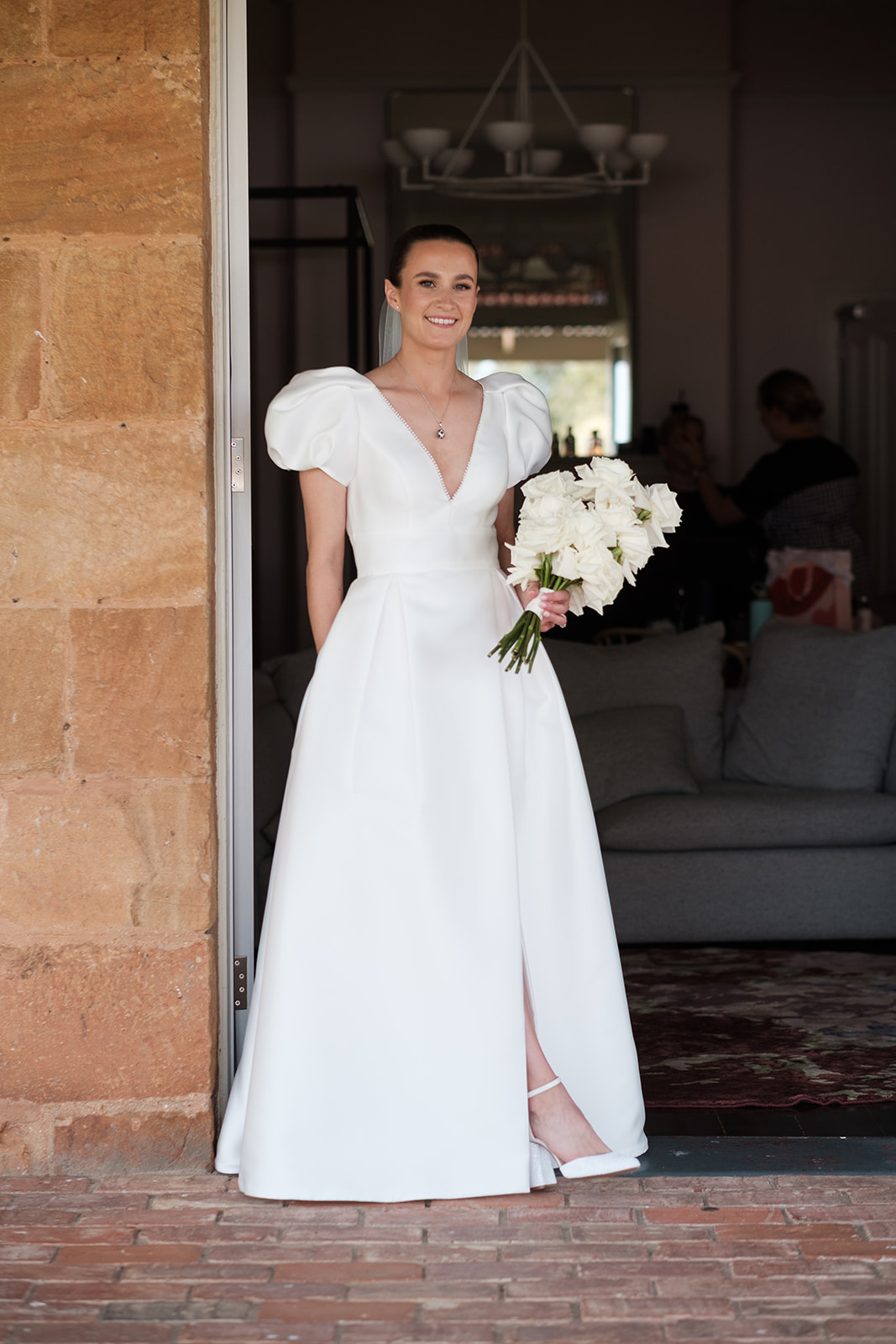 Bride Katie standing in a doorway on her wedding day at Kingsford Homestead in the Barossa Valley, South Australia