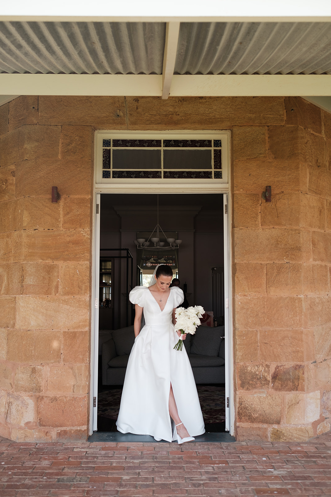 Bride Katie standing in a doorway on her wedding day at Kingsford Homestead in the Barossa Valley, South Australia