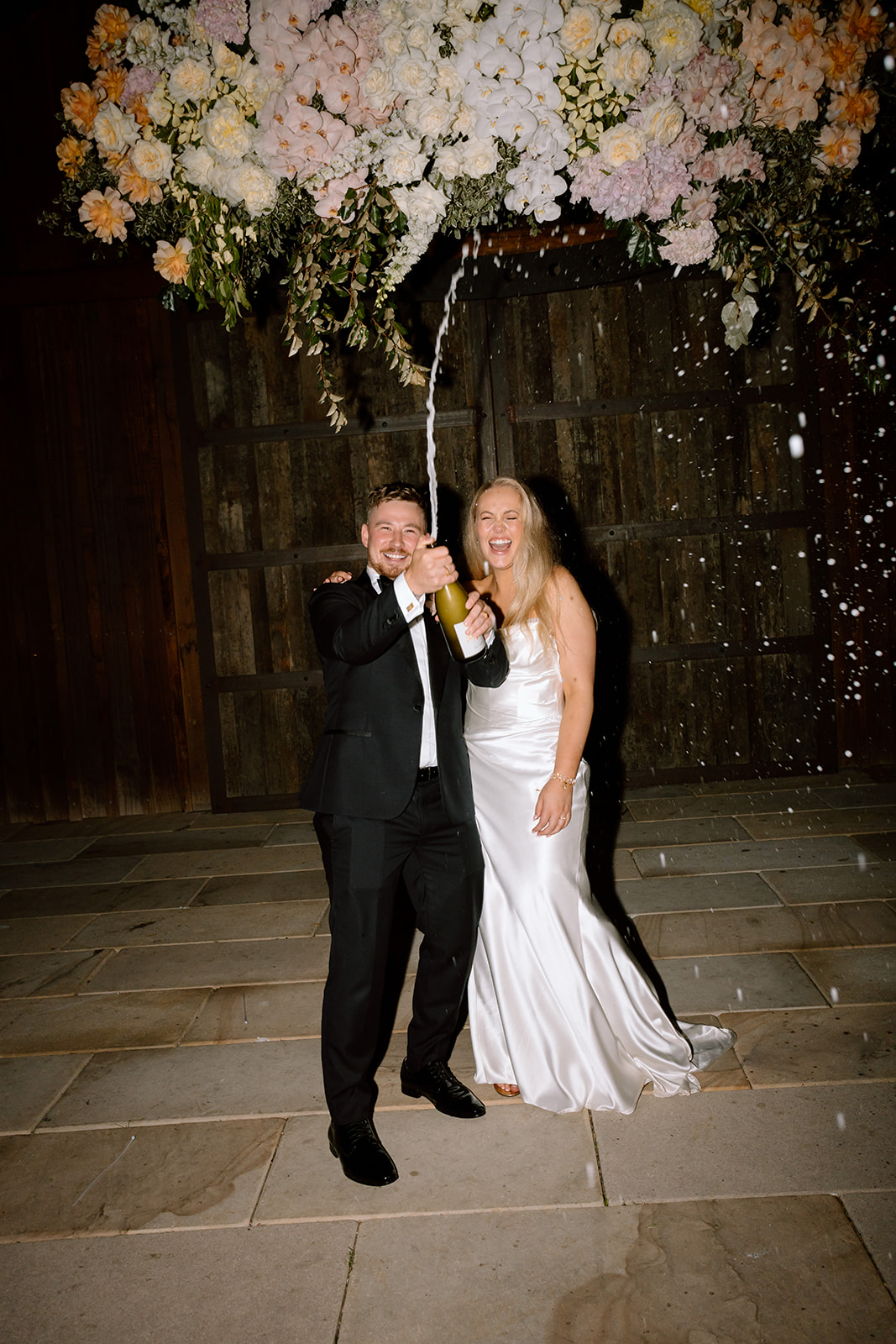 Bride and groom champagne shower at the wedding in the Southern Highlands Bendooley Estate