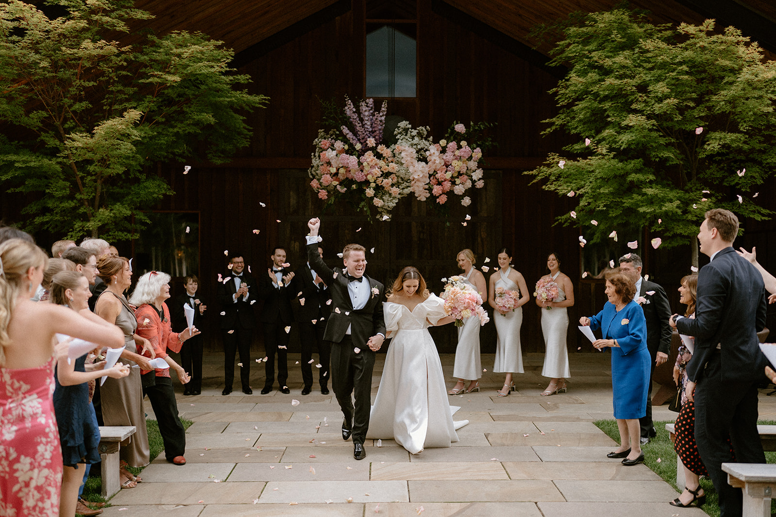 A bride and groom walking down the aisle at The Stables Bendooley Estate wedding
