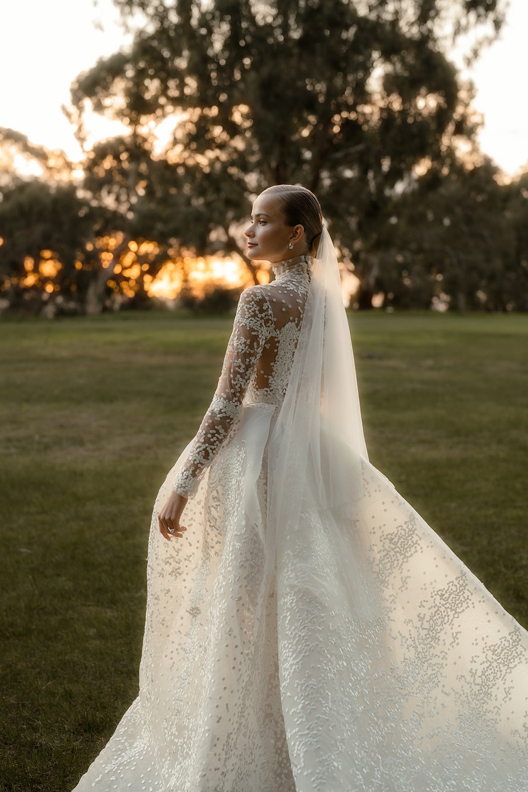 Elegant Melbourne bride in flowing white wedding gown captured in stunning golden hour portraits at Studley Park Grounds