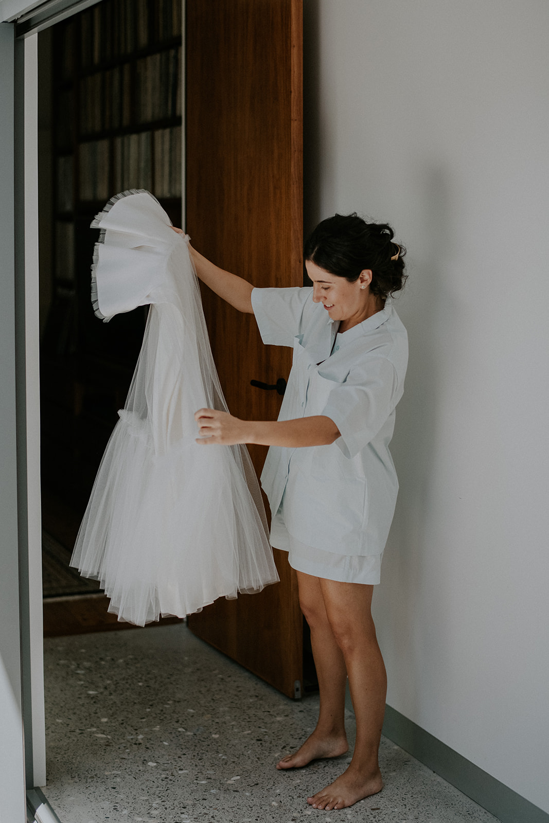 bride holding up wedding dress