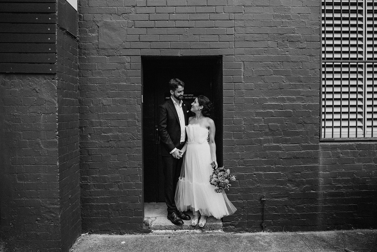 Scott Surplice bride and groom pose in doorway
