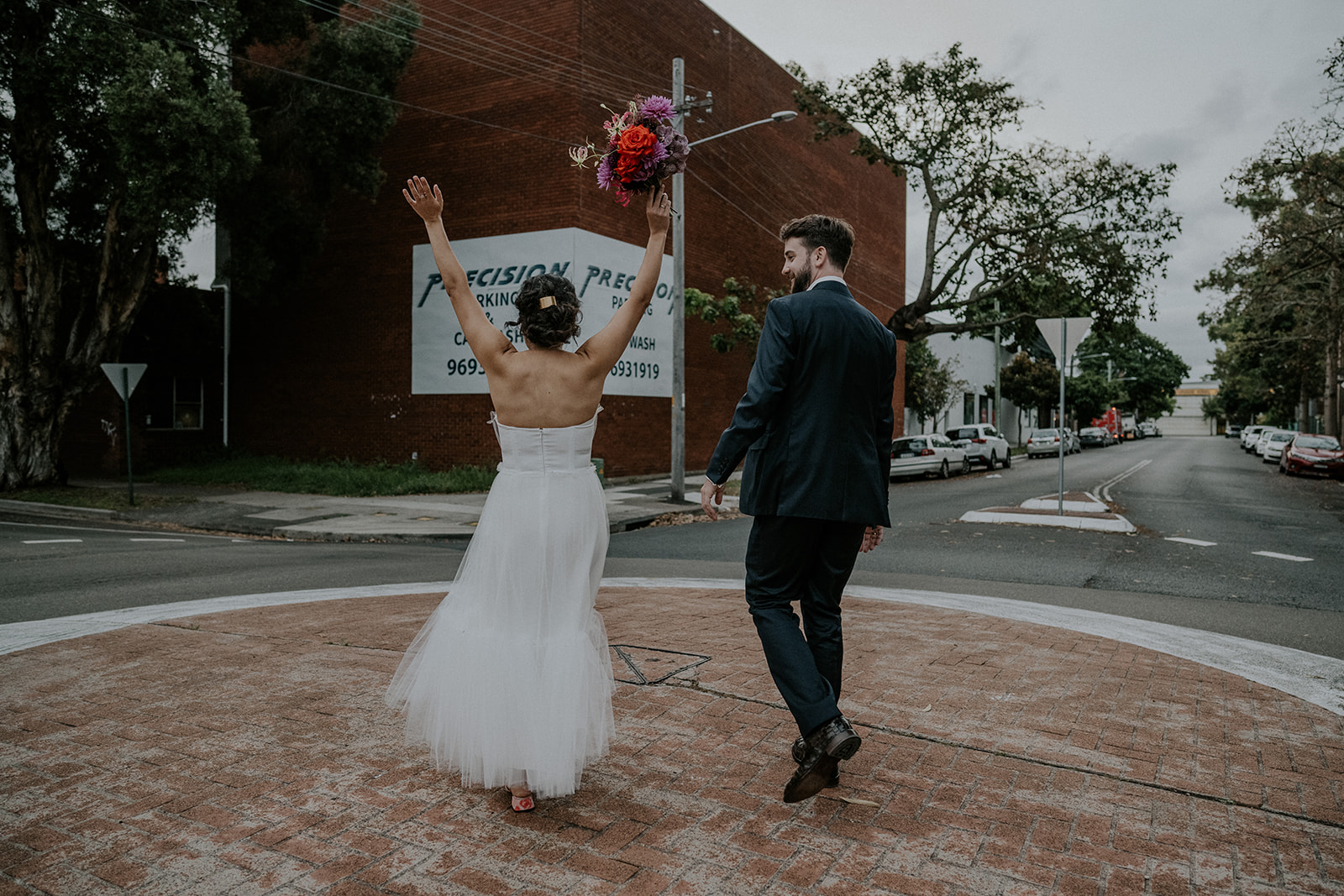 Scott Surplice bride and groom stand on a roundabout
