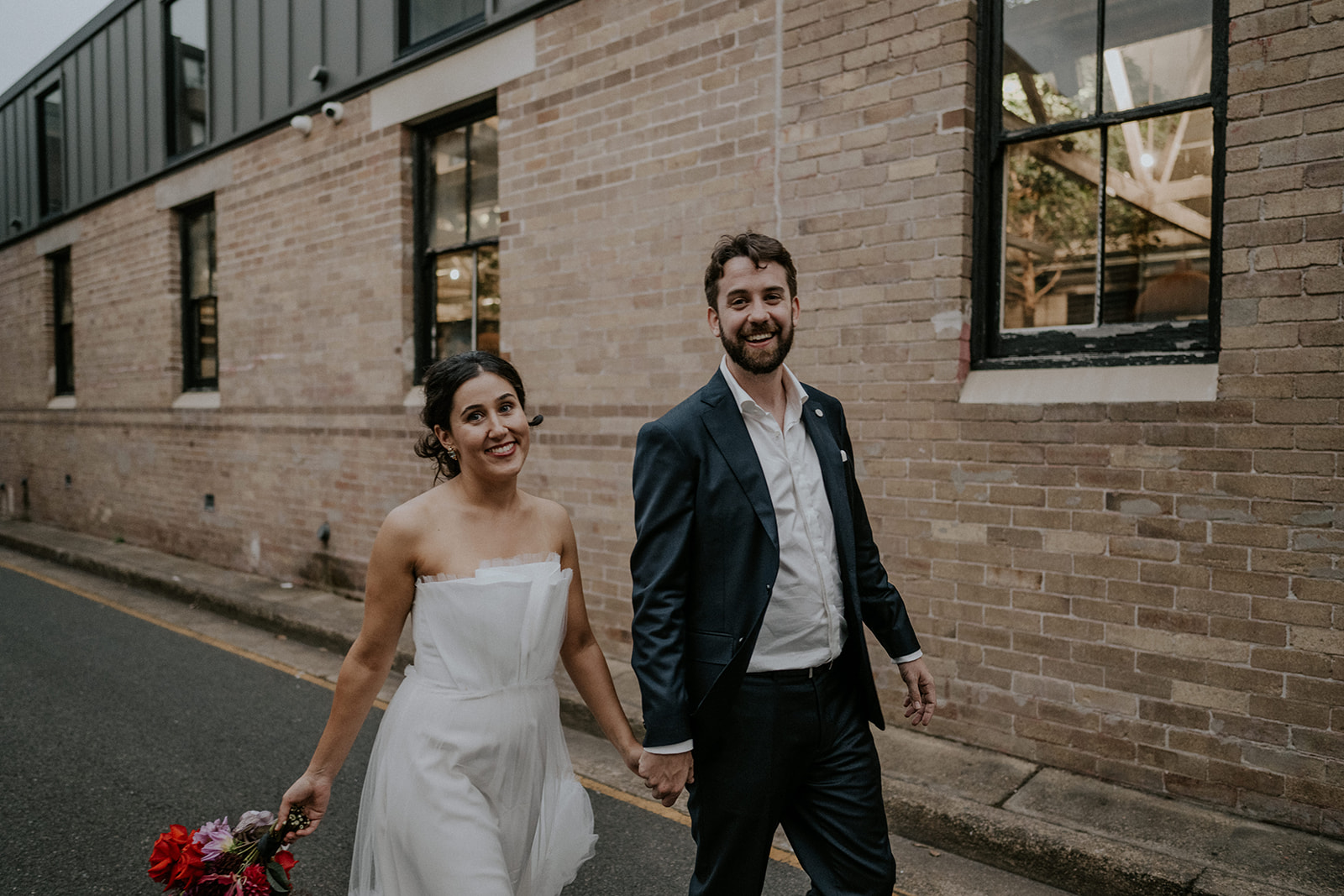 Scott Surplice portrait of bride and groom as they walk