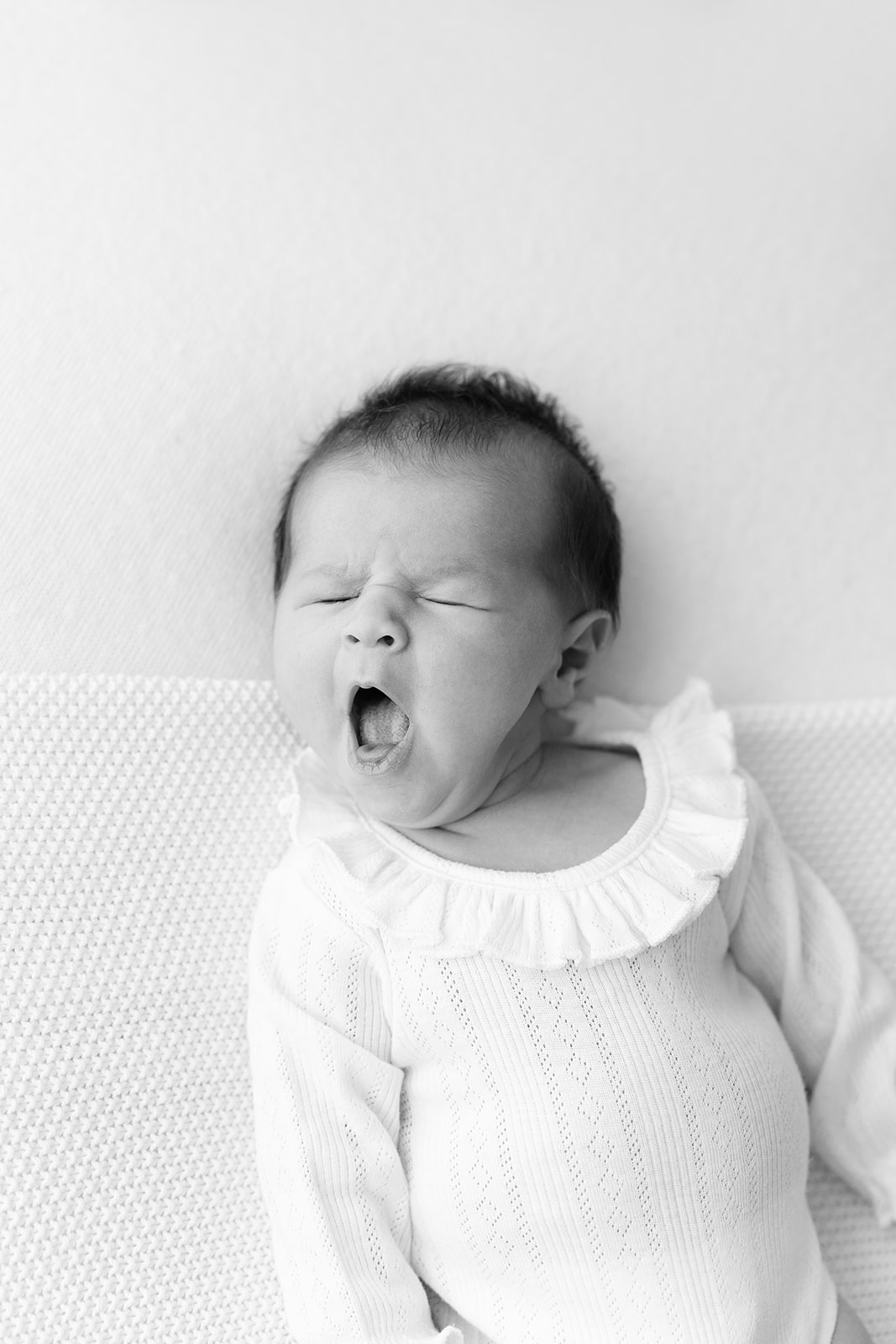 baby yawning in newborn photography studio